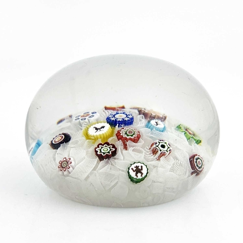 513 - Baccarat, a Gridel spaced millefiori glass paperweight, 19th century, random scattering of canes inc... 