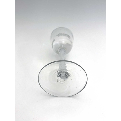 520 - An opaque twist wine glass, circa 1765, the round funnel bowl engraved with a church and disguised m... 