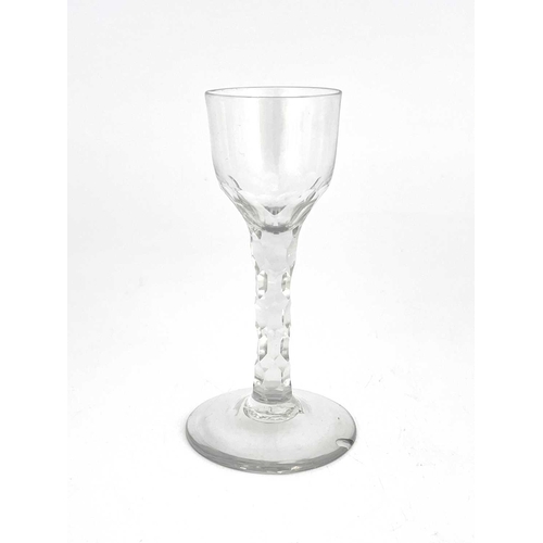 521 - A facet stem wine glass, circa 1780, the ogee bowl on a facet cut stem and conical foot, 13.5cm high... 