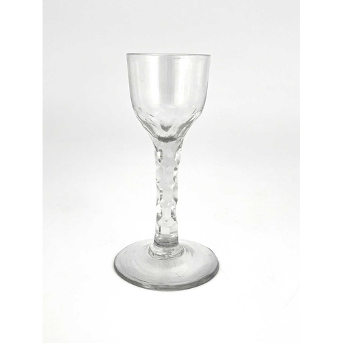 521 - A facet stem wine glass, circa 1780, the ogee bowl on a facet cut stem and conical foot, 13.5cm high... 