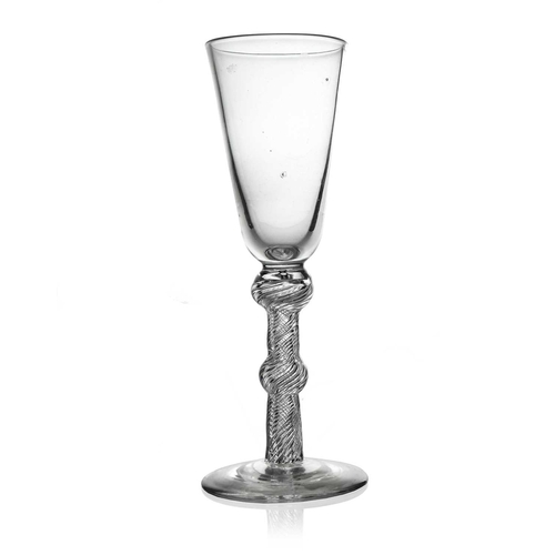 522 - An air twist glass ale or champagne flute, circa 1750, the round funnel bowl on a double knopped sin... 