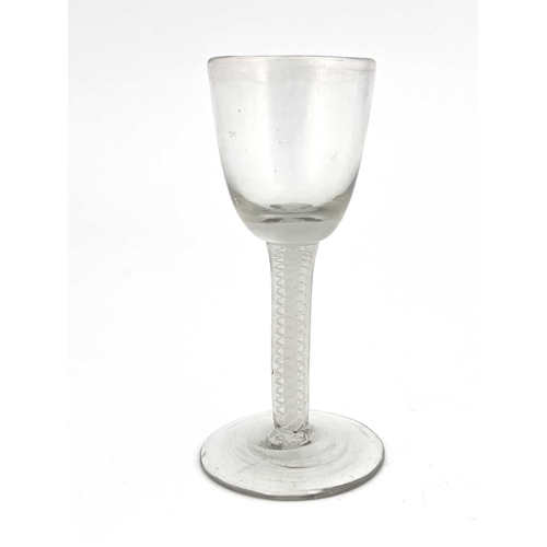 526 - An opaque twist wine glass, circa 1760, the round funnel bowl on a double series multi strand spiral... 