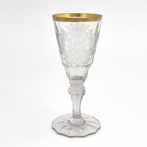 530 - A Silesian Warmbrunn engraved wine glass, the 16 panel faceted fluted funnel shaped bowl finely engr... 