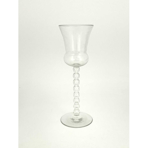 543 - James Powell and Sons, a Victorian glass stemmed vase, circa 1860, the thistle bowl on a hollow bobb... 