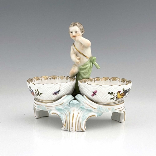 680 - A Berlin porcelain figural double salt cellar, 19th century, the central putto between two basket mo... 