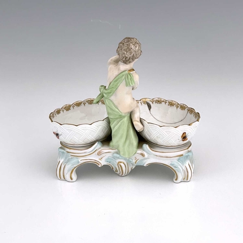 680 - A Berlin porcelain figural double salt cellar, 19th century, the central putto between two basket mo... 