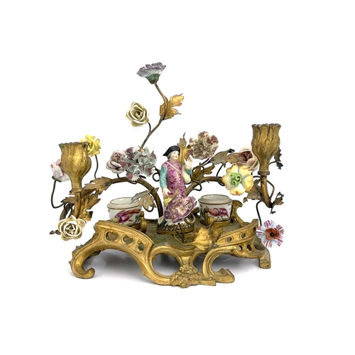 682 - A German porcelain and ormolu mounted florally encrusted figural desk stand, in the Meissen style, t... 