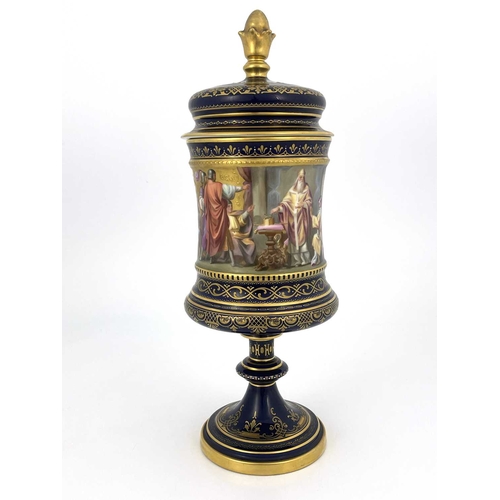 689 - A Vienna porcelain pedestal cup and cover, Campana chalice form, painted in the round with Karl von ... 