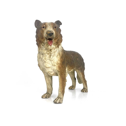 696 - A cold painted pottery figure of a dog, in the Goldscheider style, realistically modelled and set wi... 