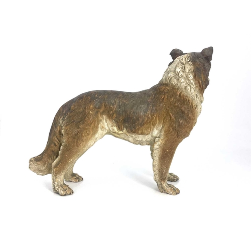 696 - A cold painted pottery figure of a dog, in the Goldscheider style, realistically modelled and set wi... 