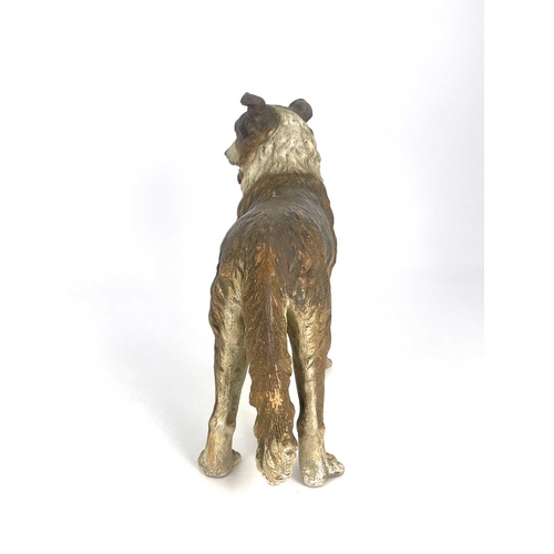 696 - A cold painted pottery figure of a dog, in the Goldscheider style, realistically modelled and set wi... 