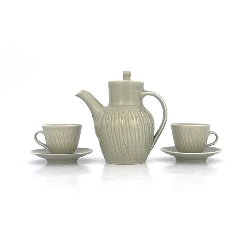 747 - Harry Davis for Crowan Pottery, a studio porcelain coffee pot and two cups and saucers, celadon glaz... 