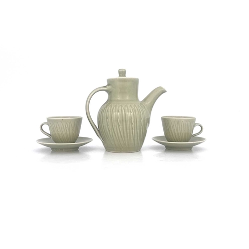 747 - Harry Davis for Crowan Pottery, a studio porcelain coffee pot and two cups and saucers, celadon glaz... 