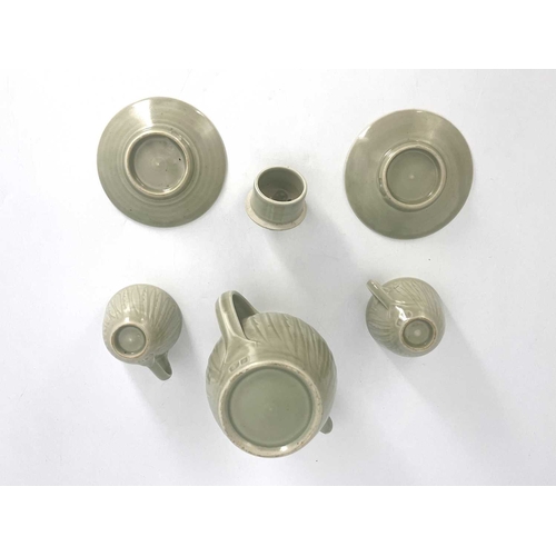 747 - Harry Davis for Crowan Pottery, a studio porcelain coffee pot and two cups and saucers, celadon glaz... 