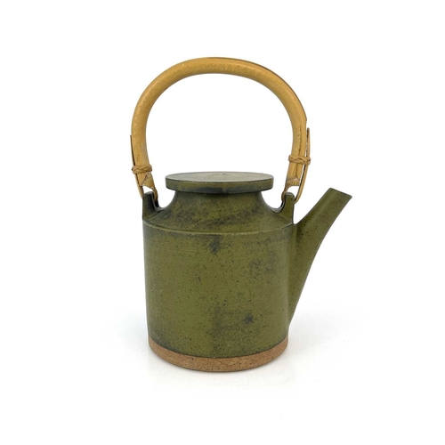 749 - Robin Welch (British, 1936- 2019), a stoneware teapot with a cane handle, impressed maker's mark nea... 