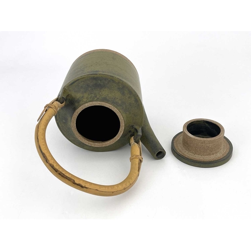 749 - Robin Welch (British, 1936- 2019), a stoneware teapot with a cane handle, impressed maker's mark nea... 