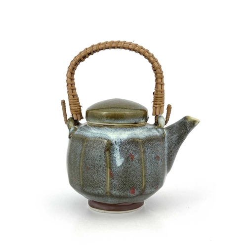 760 - Margaret Frith (British, 1943), a cut-sided stoneware teapot with a cane handle, decorated with a Ch... 