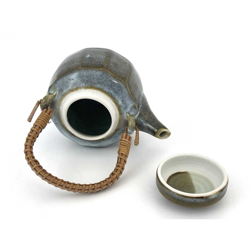 760 - Margaret Frith (British, 1943), a cut-sided stoneware teapot with a cane handle, decorated with a Ch... 