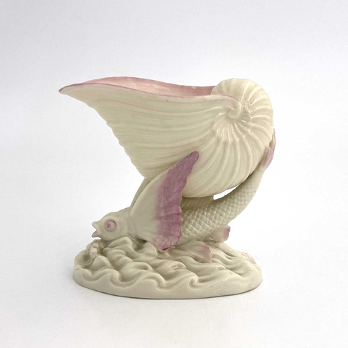 782 - A Belleek second period flying fish pedestal bowl, modelled as a shell supported by a winged fish on... 