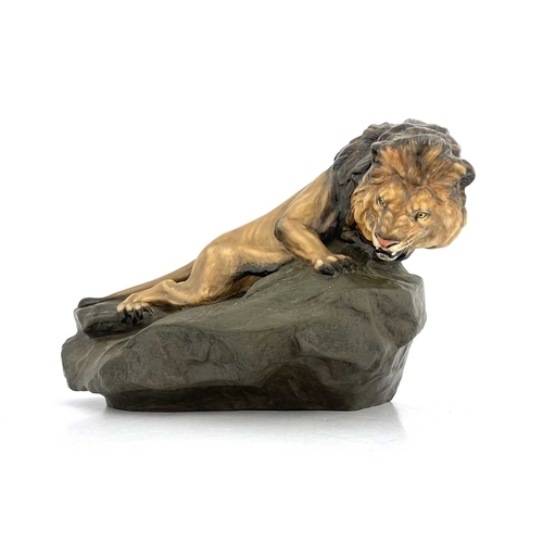 785 - A Royal Doulton figure of a lion on a rock, HN2461, gloss and matte glazed, 45cm long