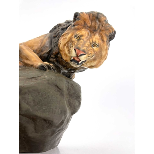 785 - A Royal Doulton figure of a lion on a rock, HN2461, gloss and matte glazed, 45cm long