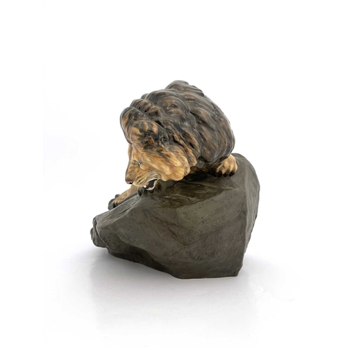 785 - A Royal Doulton figure of a lion on a rock, HN2461, gloss and matte glazed, 45cm long