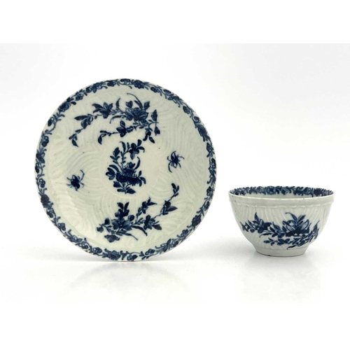 802 - A Worcester blue and white tea bowl and saucer, workmans marks, circa 1757, in the Feather Mould Flo... 