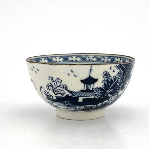 818 - A Lowestoft blue and white tea bowl, circa 1770, painted with a Chinese landscape of pagodas and isl... 