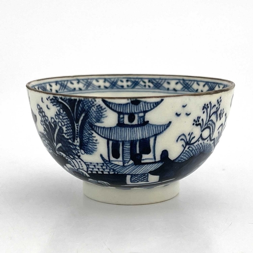 818 - A Lowestoft blue and white tea bowl, circa 1770, painted with a Chinese landscape of pagodas and isl... 