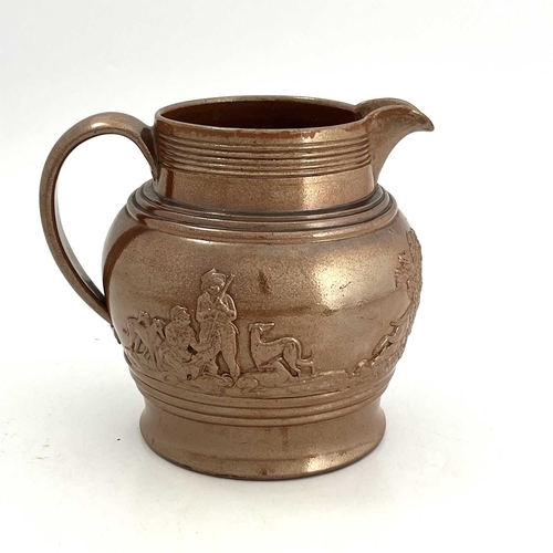 820 - A large brown glazed jug, circa 1820, relief moulded with rural hunting scene. 23 cm tall.