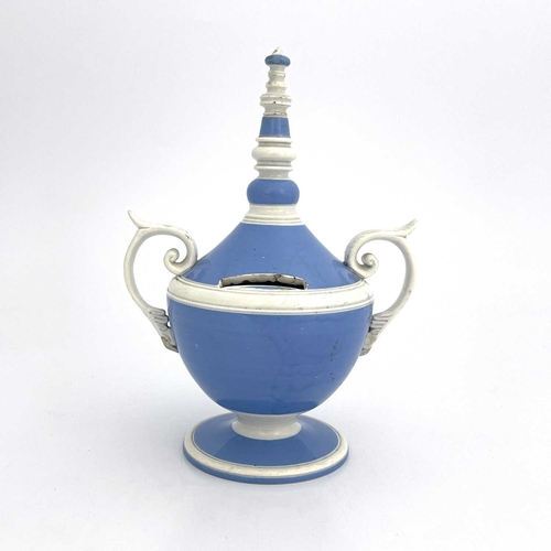 832 - A pearlware twin handled money box, circa 1800, pedestal urn form glazed in blue and white, with bob... 