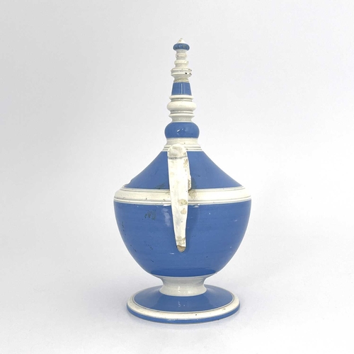 832 - A pearlware twin handled money box, circa 1800, pedestal urn form glazed in blue and white, with bob... 