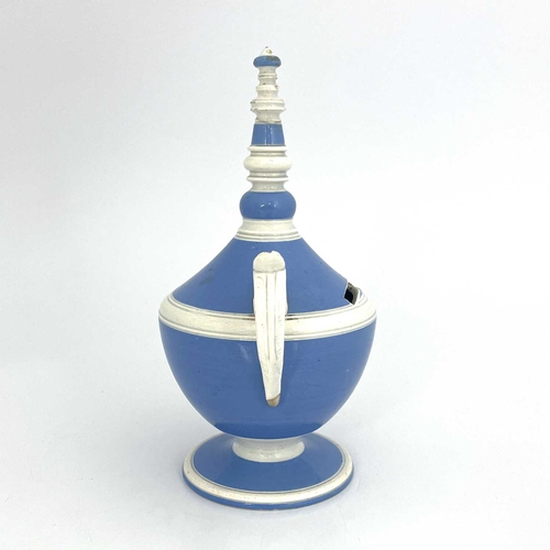 832 - A pearlware twin handled money box, circa 1800, pedestal urn form glazed in blue and white, with bob... 