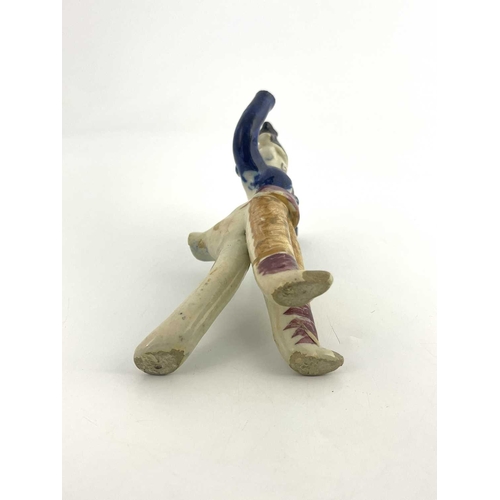 838 - A Staffordshire pottery figural whistle, 19th century, modelled as a man with arms raised, polychrom... 