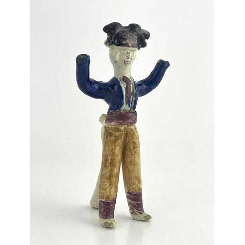 838 - A Staffordshire pottery figural whistle, 19th century, modelled as a man with arms raised, polychrom... 