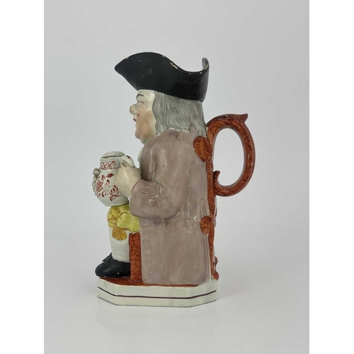 850 - A Staffordshire Toby jug, modelled with a frothing jug and pipe, yellow breeches, lilac coat and gre... 