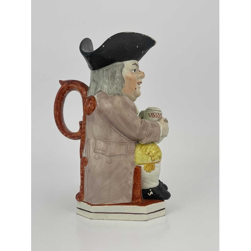 850 - A Staffordshire Toby jug, modelled with a frothing jug and pipe, yellow breeches, lilac coat and gre... 