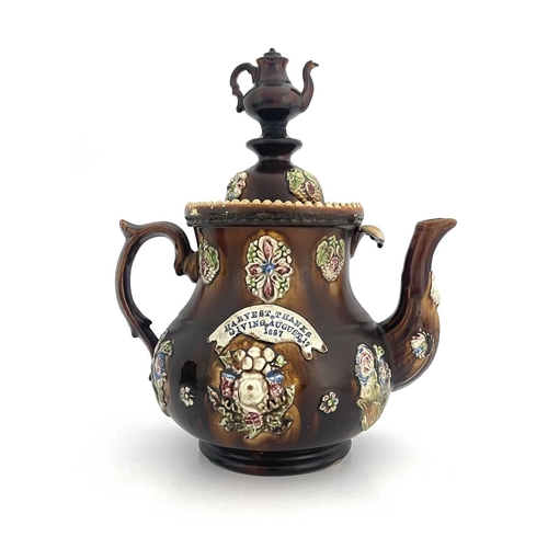 858 - A large Measham Bargeware teapot, circa 1880, baluster form, decorated with flower and foliate sprig... 