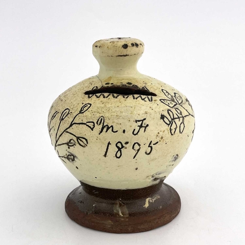 865 - A slip-decorated money box, dated 1895 with initials 