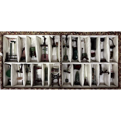 47 - A collection of Chinese carved hardstone and jadeite miniature musical instruments, cased