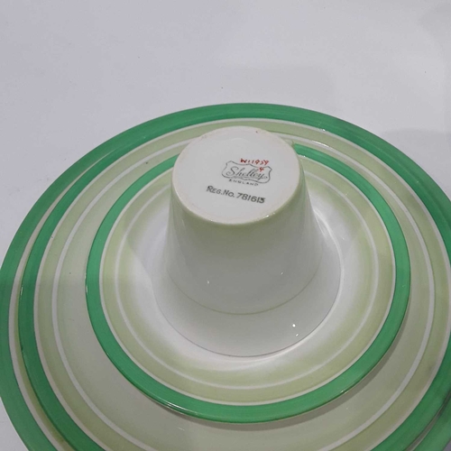 48 - A Shelley part dinner and tea service, decorated with concentric bands of graded green bands, compri... 