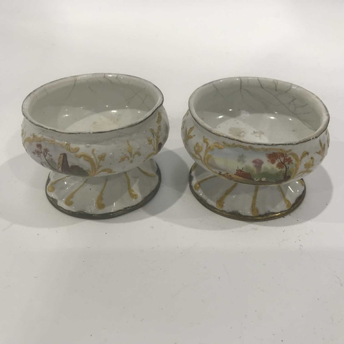 159 - A pair of Bilston/Battersea style white enamelled salts, circular footed form, early 19th century, d... 