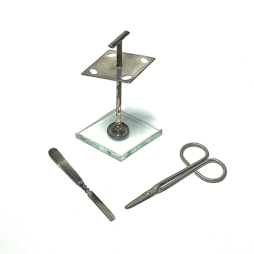 200 - An Art Deco silver part manicure set, pierced diamond form stand on similar chamfered glass base, Bi... 