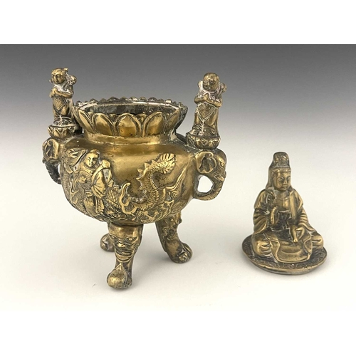 212 - An Oriental bronze censer, modelled in relief with a figure on a dragon to each side, the lid with G... 