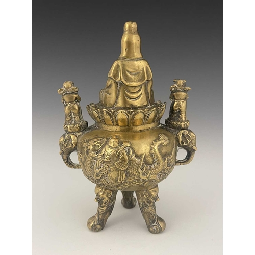 212 - An Oriental bronze censer, modelled in relief with a figure on a dragon to each side, the lid with G... 