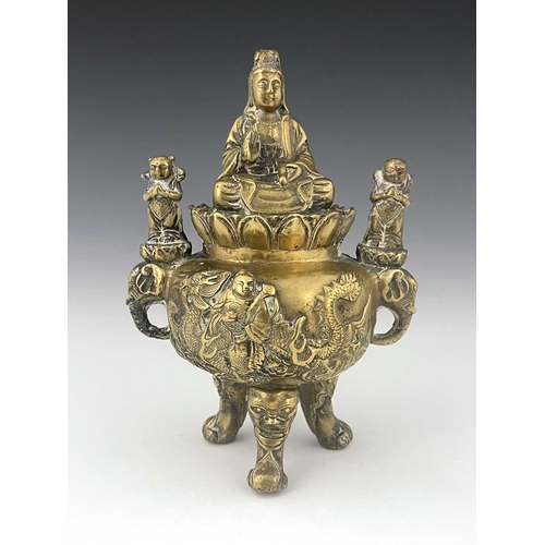 212 - An Oriental bronze censer, modelled in relief with a figure on a dragon to each side, the lid with G... 