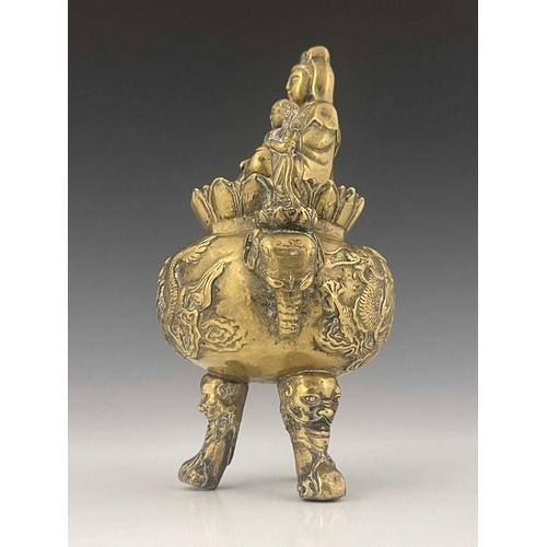 212 - An Oriental bronze censer, modelled in relief with a figure on a dragon to each side, the lid with G... 