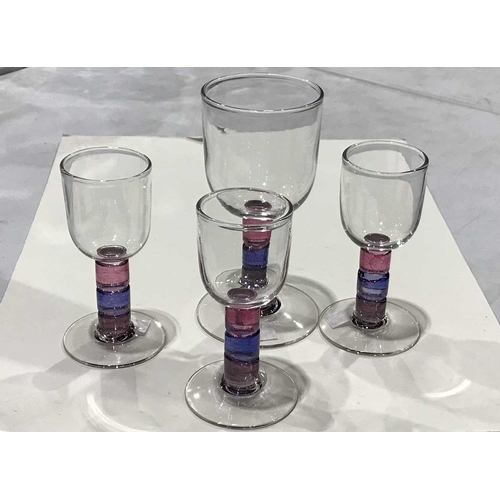 260 - Four studio glass wine glasses, three port glasses and a goblet, multi-coloured stems, indistinctly ... 