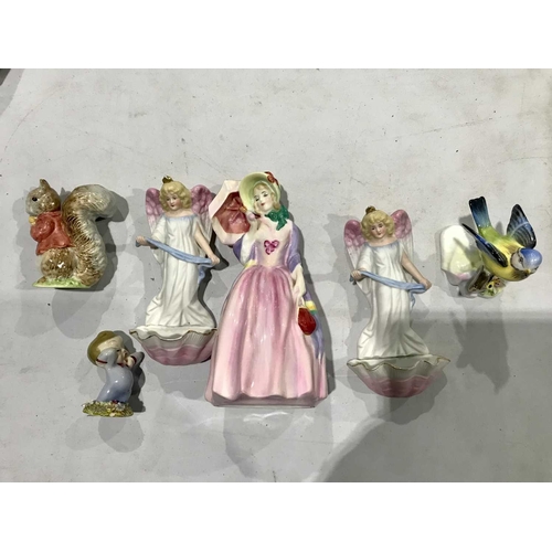 282 - A Collection of ceramic figures, including A Royal Doulton figure, Miss Demure, HN1402, a Wade figur... 