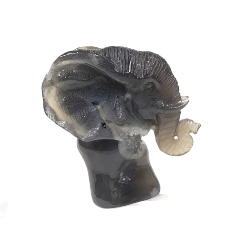 299 - A Chalcedony and quartz-carved model of an elephant, 12cm high